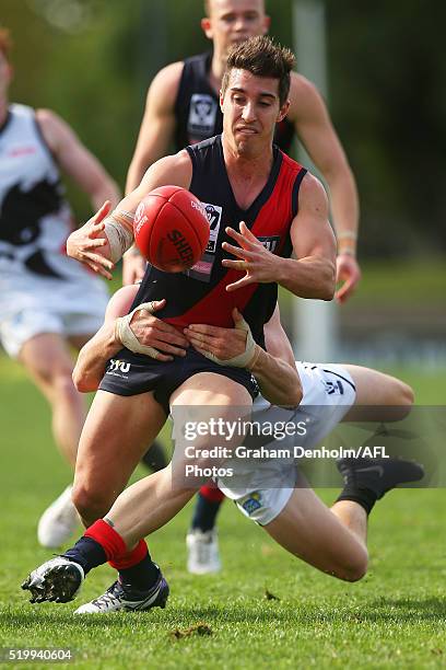 Nathan Thomas of Coburg is tackled during the round one VFL match between Coburg and North Ballarat at Piranha Park on April 9, 2016 in Melbourne,...