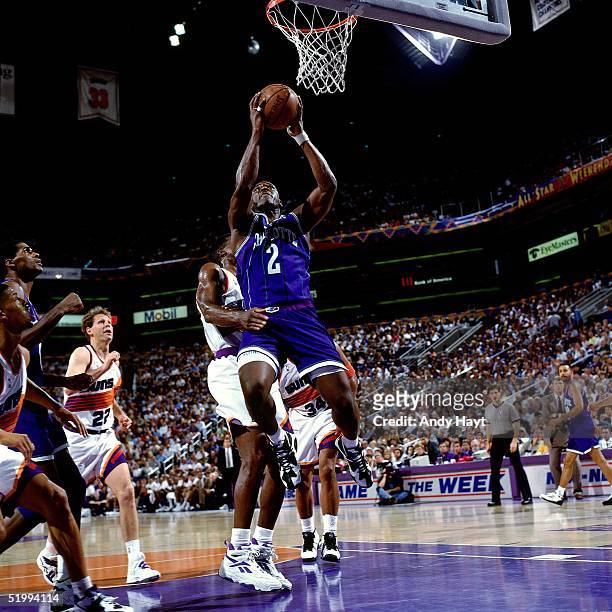 Larry Johnson of the Charlotte Hornets puts a shot from under the basket against the Phoenix Suns during an NBA game at America West Arena on...