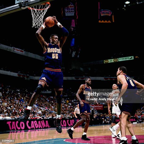 Dikembe Mutombo of the Denver Nuggets grabs a rebound against the San Antonio Spurs during an NBA game at the Alamo dome on January 28, 1995 in San...