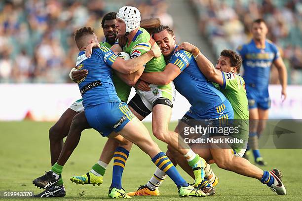 Clint Gutherson and Brad Takairangi of the Eels attempt to tackle Jarrod Croker of the Raiders into touch as Edrick Lee and Josh Papalii of the...