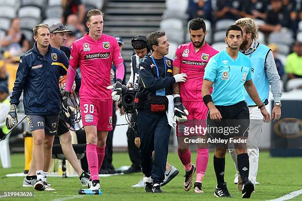 Paul Izzo of the Mariners is walked off the ground injured during the round 27 A-League match between the Central Coast Mariners and the Newcastle...