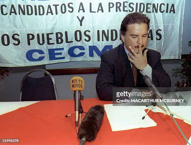Guatemalan presidential candidate Alfonso Portillo of the Guatemalan Republican Front waits in vain for rival candidate Alvaro Arzu of the National...