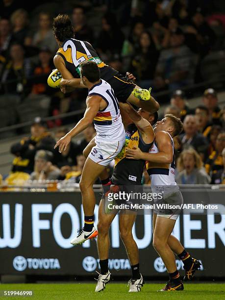 Sam Lloyd of the Tigers takes a spectacular mark over Luke Brown and Rory Laird of the Crows and teammate Shane Edwards of the Tigers during the 2016...