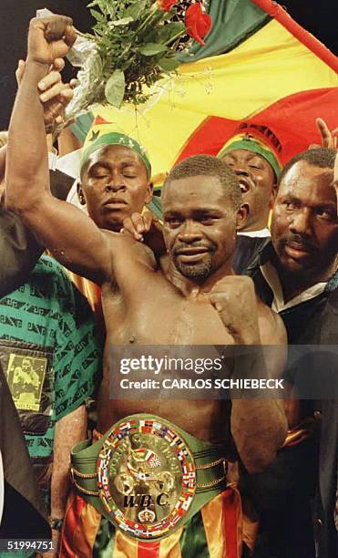 Ghana's Azumah Nelson of Ghana holds up his arm in victory after he took the WBC Super featherweight title bout from Mexico's Gabriel Ruelas with a...