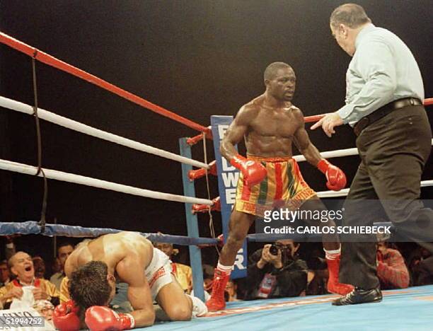 Referee Marty Denkin waves Ghana's Azumah Nelson to a neutral corner after he knocked Mexico's Gabriel Ruelas down in the second round of their WBC...