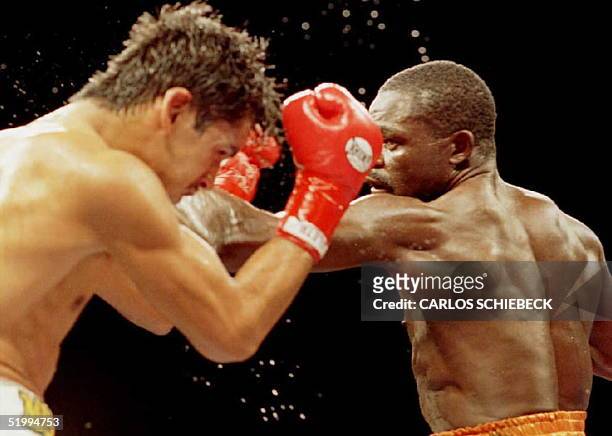 Azumah Nelson of Ghana throws a hard punch to the head of Gabriel Ruelas in the first round of their scheduled 12 round WBC Super featherweight title...