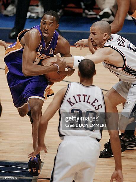 Los Angeles Lakers Kobe Bryant drives past New Jersey Nets' Kerry Kittles and Jason Kidd during first quarter action in game three of the NBA Finals...