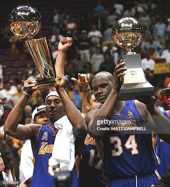 Los Angeles Lakers Kobe Bryant and Shaquille O'Neal hold up the Championship and MVP trophys after game four of the NBA Finals against the New Jersey...