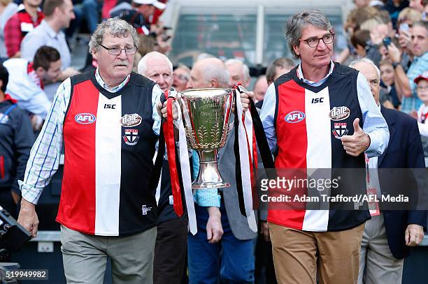 Premiership players Kevin 'Cowboy' Neale and Barry Breen bring out the 1966 Premiership cup during the 2016 AFL Round 03 match between the St Kilda...