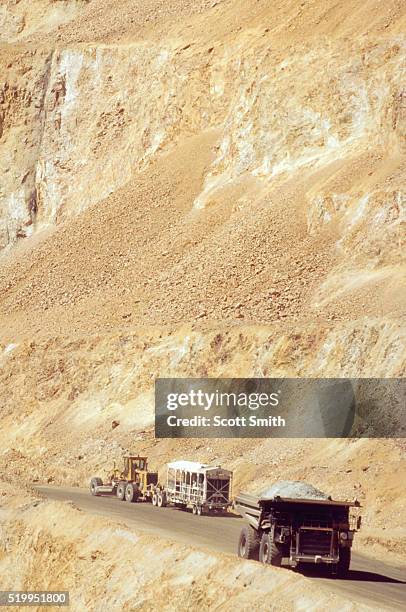 mining trucks at kennecott copper mine - bingham canyon mine stock pictures, royalty-free photos & images