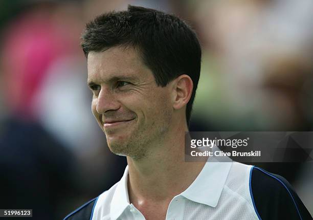 Tim Henman of England has a laugh over a line call during his match against Andre Agassi of the United States during day four of the 2005 Kooyong...