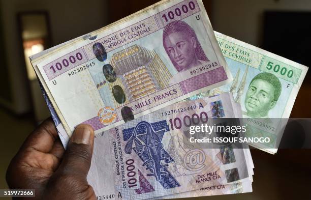 This photo taken on April 9, 2016 in a N'Djamena, Chad, shows CFA banknotes of the CFA currency issued by the Central Bank of West African States and...