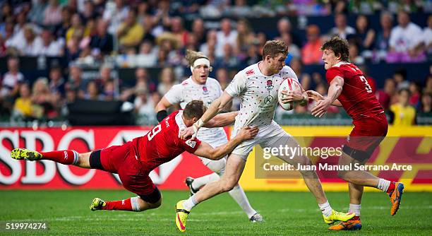 Ruaridh McConnochie of England is tackled during the 2016 Hong Kong Sevens match between England and Russia at Hong Kong Stadium on April 9, 2016 in...