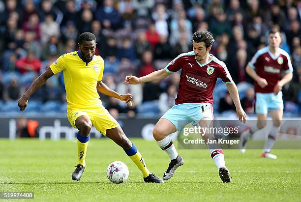 Joey Barton of Burnley competes for the ball with Mustapha Carayol of Leeds during the Sky Bet Championship match between Burnley and Leeds United at...