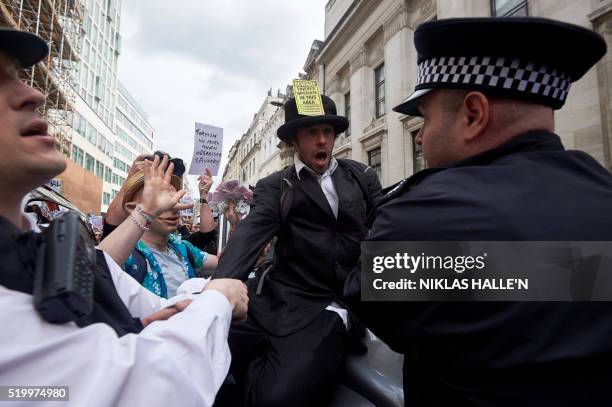 Protesters demonstrate against British Prime Minister David Cameron outside the Conservative Party's Spring Forum in central London following...