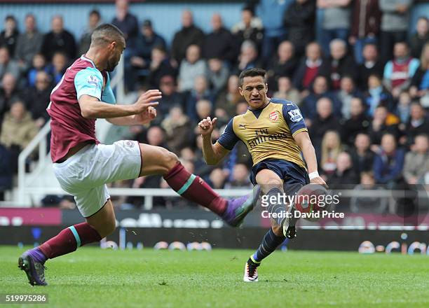 Alexis Sanchez scores Arsenal's second goal under pressure from Winston Reid of West Ham during the Barclays Premier League match between West Ham...