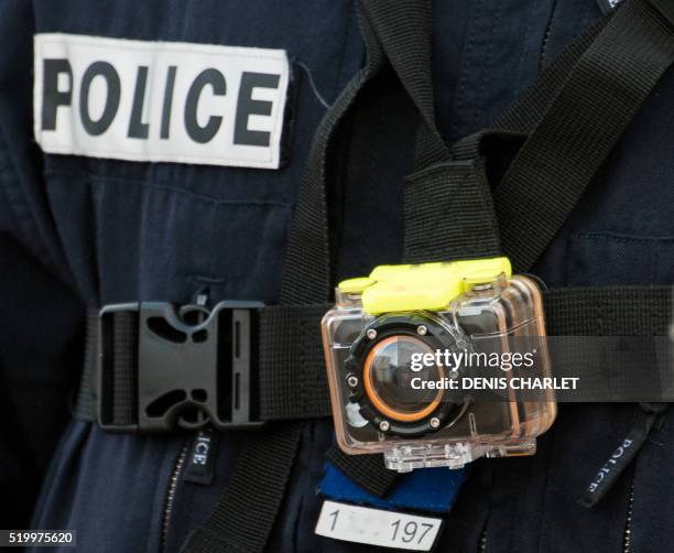 Picture taken on March 2, 2016 shows a police officer wearing a body-worn camera in Calais. French Interior Minister Bernard Cazeneuve said on April...