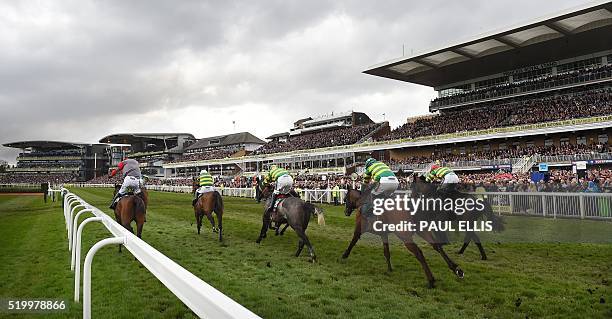 Riders and horses compete in the first race of the day, The Gaskells Waste Management Handcap Hurdle, on the final day of the Grand National Festival...