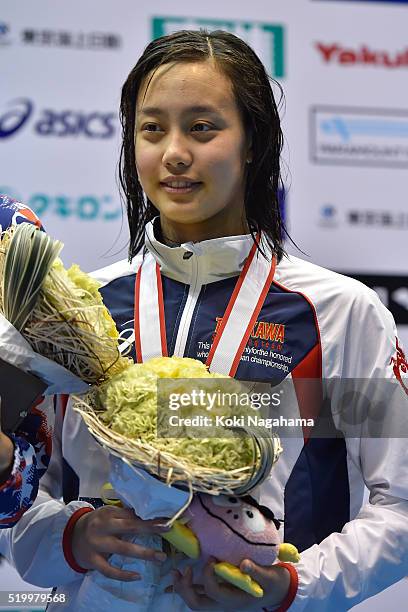 Runa Imai poses for pgotographs on the podium after the Women's 200m Breaststroke final during the Japan Swim 2016 at Tokyo Tatsumi International...