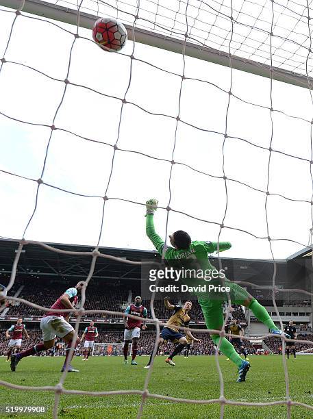 Laurent Koscielny scores Arsenal's 3rd goal past Adrian of West Ham during the Barclays Premier League match between West Ham United and Arsenal at...