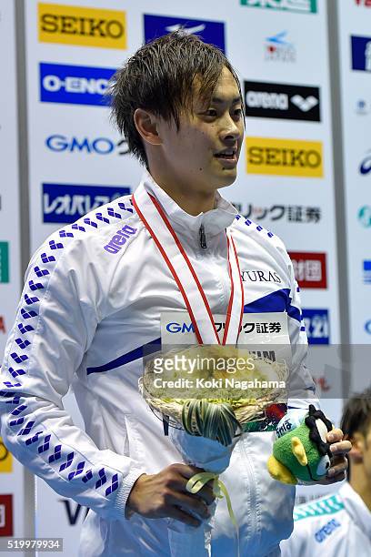Silver medalist Masaki Kaneko poses for photographs on the podium after the Men's 200m Backstroke final during the Japan Swim 2016 at Tokyo Tatsumi...