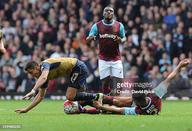Alexis Sanchez of Arsenal is challenged by Winston Reid of West Ham during the Barclays Premier League match between West Ham United and Arsenal at...