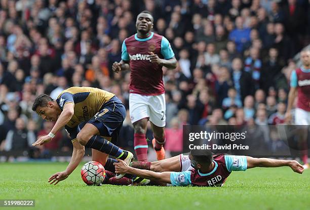 Alexis Sanchez of Arsenal is challenged by Winston Reid of West Ham during the Barclays Premier League match between West Ham United and Arsenal at...