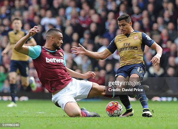 Alexis Sanchez of Arsenal is challenged by Winston Reid of West Ham during the Barclays Premier League match between West Ham United and Arsenal at...