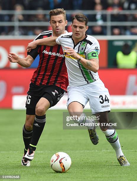 Ingolstadt's Austrian striker Lukas Hinterseer and Moenchengladbach's Swiss midfielder Granit Xhaka vie for the ball during the German first division...