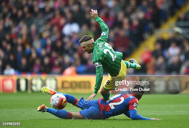 Gary O'Neil of Norwich City is tackled by Jason Puncheon of Crystal Palace during the Barclays Premier League match between Crystal Palace and...