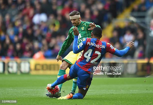 Gary O'Neil of Norwich City is tackled by Jason Puncheon of Crystal Palace during the Barclays Premier League match between Crystal Palace and...