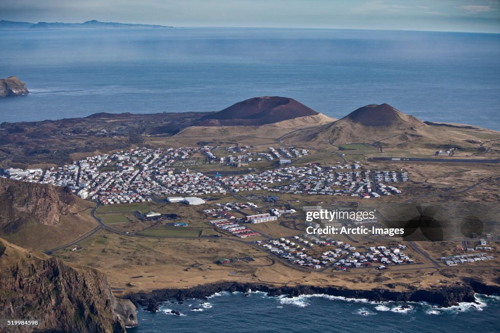 Heimaey, volcanic islands, Westman Islands, Iceland 2010Heimaey a fishing village is nestled between the ocean and the Helgafjell Volcano, which last erupted 1973, spurting tons of molten lava into the sky.