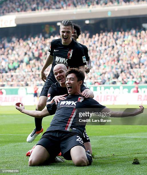 Jeon Ho Hong of Augsburg celebrates after scoring his teams winning goal during the Bundesliga match between Werder Bremen and FC Augsburg at...
