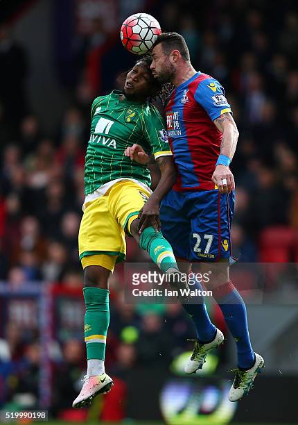 Dieumerci Mbokani of Norwich City and Damien Delaney of Crystal Palace compete for the ball during the Barclays Premier League match between Crystal...