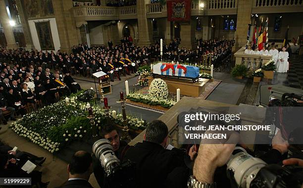 Photographers are at work in side Notre Dame of Luxembourg cathedral during the funeral of Grand Duchess Josephine Charlotte 15 January 2005 in...