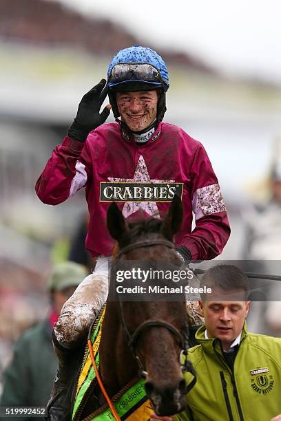 David Mullins celebrates as he enters the Winners' Enclosure after riding Rule The World to victory in the 2016 Crabbie's Grand National at Aintree...