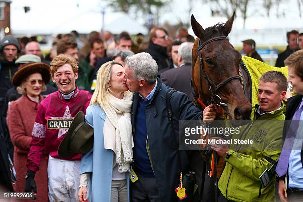 Owner Michael O'Leary kisses his wife Anita O'Leary as David Mullins smiles in the Winners' Enclosure after riding Rule The World to victory in the...
