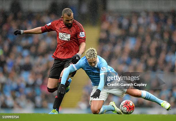 Samir Nasri of Manchester City is challenged by Sandro of West Bromwich Albion during the Barclays Premier League match between Manchester City and...