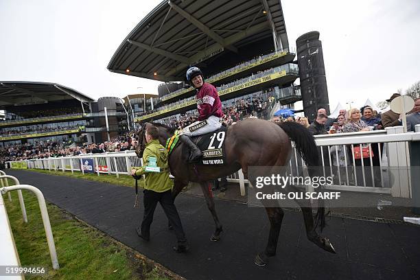 David Mullins riding 'Rule the World' is led from the field after winning The Grand National Steeple Chase on the final day of the Grand National...