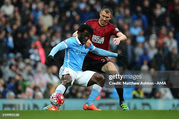 Garetrh McAuley of West Bromwich Albion tangles with Wilfried Bony of Manchester City during the Barclays Premier League match between Manchester...