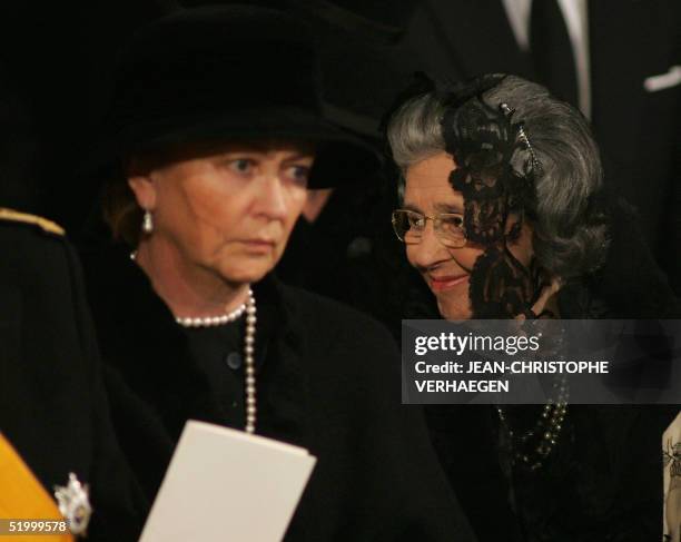 Queen Fabiola of Belgium smiles as Queen Paola looks on during the funeral of Luxembourg Grand Duchess Josephine-Charlotte at the Notre Dame...