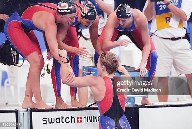 Amy Van Dyken, Dara Torres, and Courtney Shealy of the USA women's 4x100 meter freestyle swimming relay team congratulate teammate Jenny Thompson...