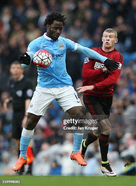 Wilfried Bony of Manchester City is challenged by James McClean of West Bromwich Albion during the Barclays Premier League match between Manchester...