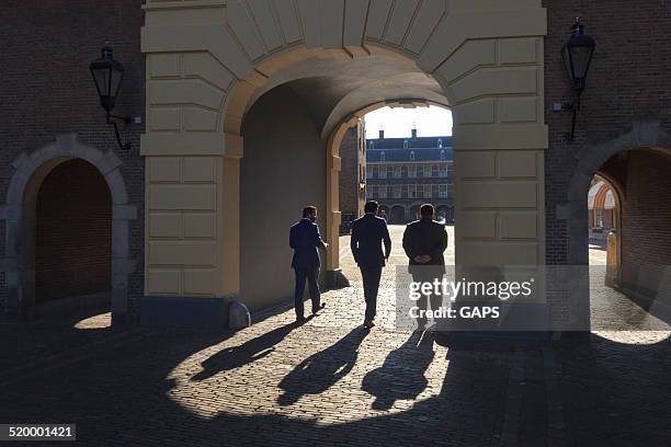 men on binnenhof in the hague - binnenhof stock pictures, royalty-free photos & images