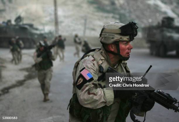 Capt. Thomas Siebold of the 1st Battalion, 5th Infantry Stryker Brigade Combat Team of the 25th Infantry Division out of Ft. Lewis, Washington covers...