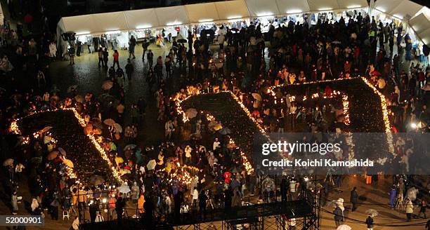 Candles posting signs of 1.17 are seen at a park in Kobe in commemorate the 10th anniversary of the 1995 earthquake in Kobe on January 17, 2005 in...