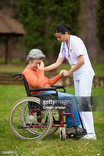 female nurse with senior woman - old lady crying out for help stock pictures, royalty-free photos & images