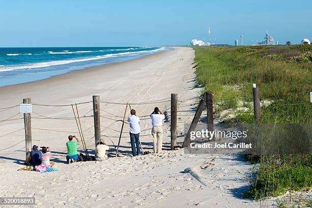 people watching rocket launch at canaveral national seashore - titusville florida stock pictures, royalty-free photos & images