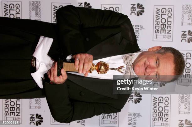 Actor Robin Williams poses with his award as recipient of the Cecil B. DeMille Award during the 62nd Annual Golden Globe Awards at the Beverly Hilton...