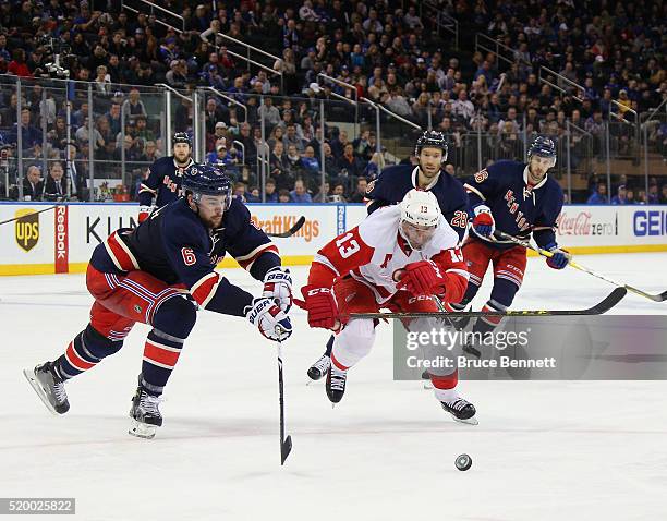 Dylan McIlrath of the New York Rangers skates against Pavel Datsyuk of the Detroit Red Wings at Madison Square Garden on April 9, 2016 in New York...